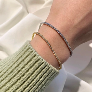 Close-up of gold and silver S925 sterling silver tennis bracelets with round zircons