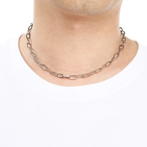 Detailed view of silver oval link chain necklace worn on model for daily style