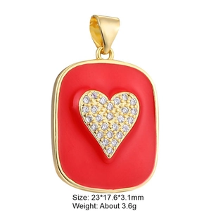 Detailed view of a gold plated red enamel heart pendant with cubic zirconia inlay