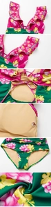 Detail view of pink grape print swimsuit showing ruffle straps and cross-back tie design