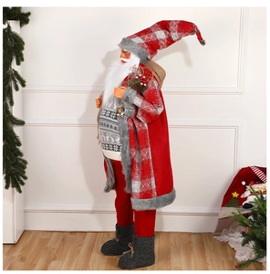 Standing Santa Claus doll with red plaid hat and gray reindeer sweater in festive setting