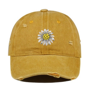 Vintage distressed mustard yellow baseball cap featuring daisy football embroidery detail