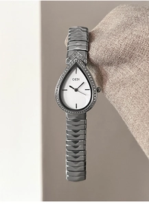 Detailed close-up of water-drop silver watch with crystal bezel on knit fabric