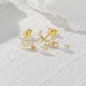 Macro view of S925 sterling silver stamp on asymmetrical pearl and zircon star moon earrings