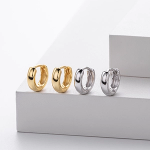 Detailed macro view of S925 sterling silver hoop earrings in gold and silver finish