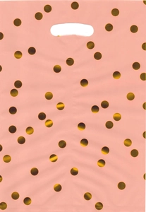 Detailed view of pink plastic gift bag with golden polka dots and die-cut handle design