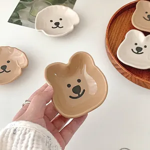 Cute cartoon bear ceramic dipping sauce dish with hand-painted face and cream finish