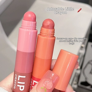 Close-up of pink and coral velvet matte lip crayon sticks held in hand for detail