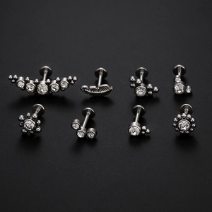 Detailed set of eight titanium steel lip and cartilage studs with cubic zirconia clusters