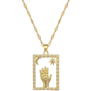 Gold Hamsa Hand necklace with crescent moon and sun pendant inlaid with crystals
