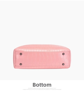 Close-up of pink crocodile pattern handbag base with four protective metal feet studs