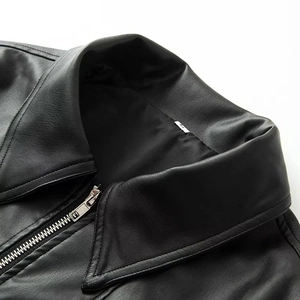 Close-up of lapel collar and metal zipper detail on black faux leather jacket
