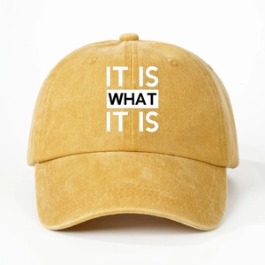 Macro view of mustard yellow washed cotton baseball cap with IT IS WHAT IT IS print