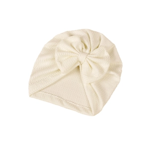 Soft white knit baby turban hat with a large decorative bow for newborns and infants