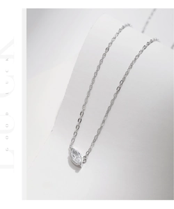 Detail of S925 sterling silver necklace with marquise-cut zircon pendant and cross chain