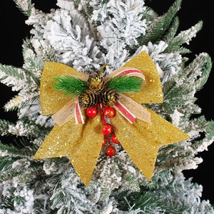 Golden Christmas tree bow with glitter fabric, pine cones and red berries decor