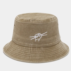 Detailed close-up of khaki washed canvas bucket hat featuring drumstick hand embroidery