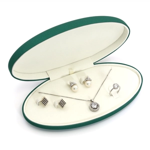 Deep green faux leather oval jewelry box set with necklace earrings and ring slots