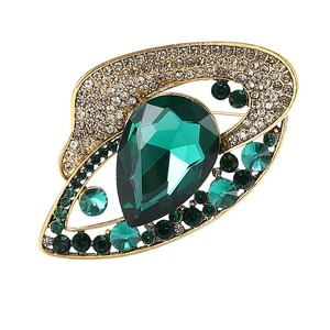 Vintage gold brooch featuring a large green teardrop stone and crystal accents on white background