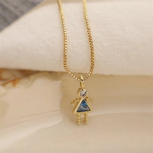 Close-up of a gold necklace featuring a girl pendant with blue triangle gemstone detail