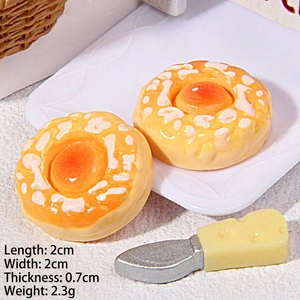 Miniature resin bread dollhouse food model with tiny spatula on a small white plate