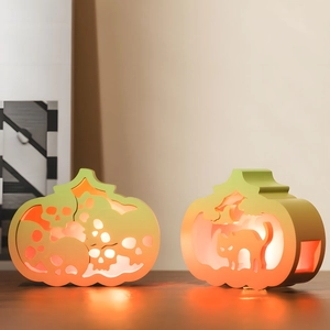 Halloween pumpkin LED lanterns with skull and cat hollow designs for festive desk decor