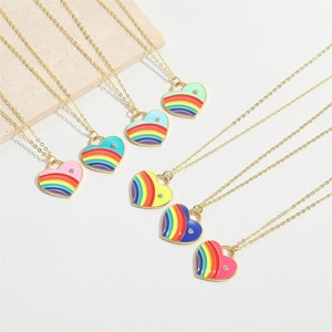 Macro detail of rainbow heart pendants with gold chains and sparkling diamond accents