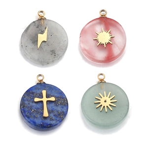 Macro shot of stainless steel gemstone pendants with gold sun and star inlay details