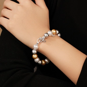925 sterling silver pearl bracelet with mixed colors and diamond clover clasp on wrist