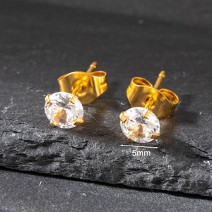 Macro shot of 5mm round cubic zirconia stud earring with golden stainless steel base