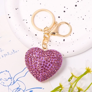 Detail of purple crystal heart keychain with sparkling rhinestones and gold-tone clasp