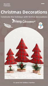 Detail of three plaid Christmas tree ornaments with pine needles and red berries on wooden base