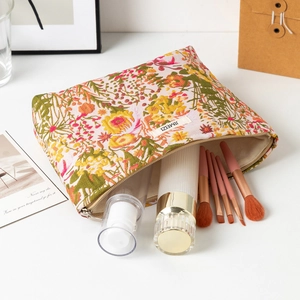 Detail view of large capacity floral jacquard cosmetic bag with smooth metal zipper