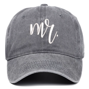 Detailed view of white Mr. embroidery on vintage washed grey denim baseball cap fabric