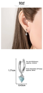 Detailed view of silver heart drop earrings with dimensions of 1.71cm by 0.43cm