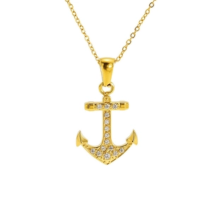 Macro detail of gold anchor pendant with white zircon micro-pave setting on white background