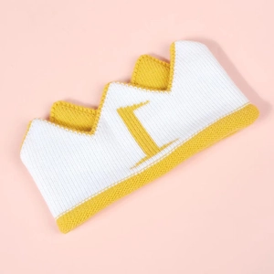 Detailed close-up of the knitted texture on this yellow and white crown baby headband