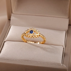 Detail shot of golden Evil Eye ring with deep blue zircon and intricate bead texture