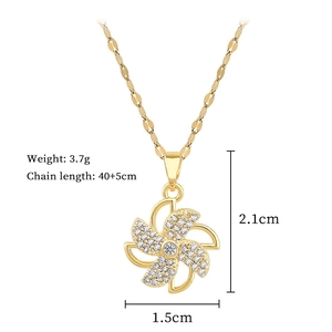 Macro view of gold windmill pendant showing size 2.1cm by 1.5cm and 3.7g weight