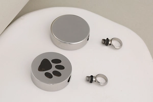 Polished stainless steel pet cremation pendant with round paw print and screw closure