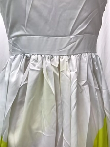 Detail of white pleated waist design with yellow print on slim fit summer maxi dress