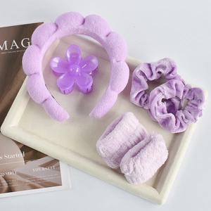 Close-up of lavender purple hair accessory set with headband and flower claw clip