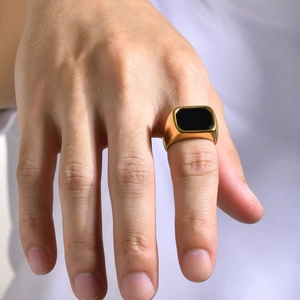 Detailed view of men's gold stainless steel ring featuring a black rectangular stone