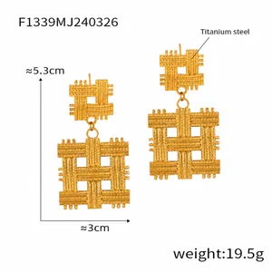 Detail view of gold-plated titanium steel earrings with geometric woven texture design