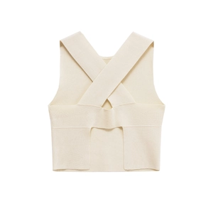 Detail view of cream-white knitted top with crossover straps and high-quality texture