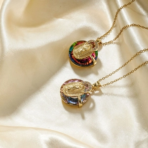 Exquisite gold pendant necklace featuring colorful crystal and Virgin Mary religious relief