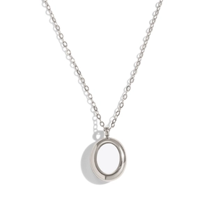 Detailed view of silver oval ring pendant with smooth metallic luster on white backdrop
