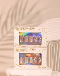 Close-up of sparkling cat eye press-on nails with silver rhinestones in elegant gift boxes