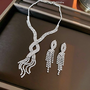 Macro view of silver fringe tassel necklace and earrings set with clear crystals