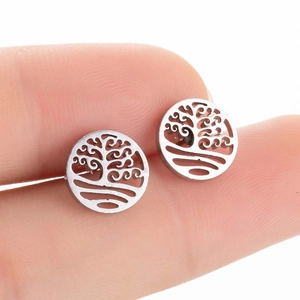 Silver Tree of Life geometric stud earrings in stainless steel held by hand